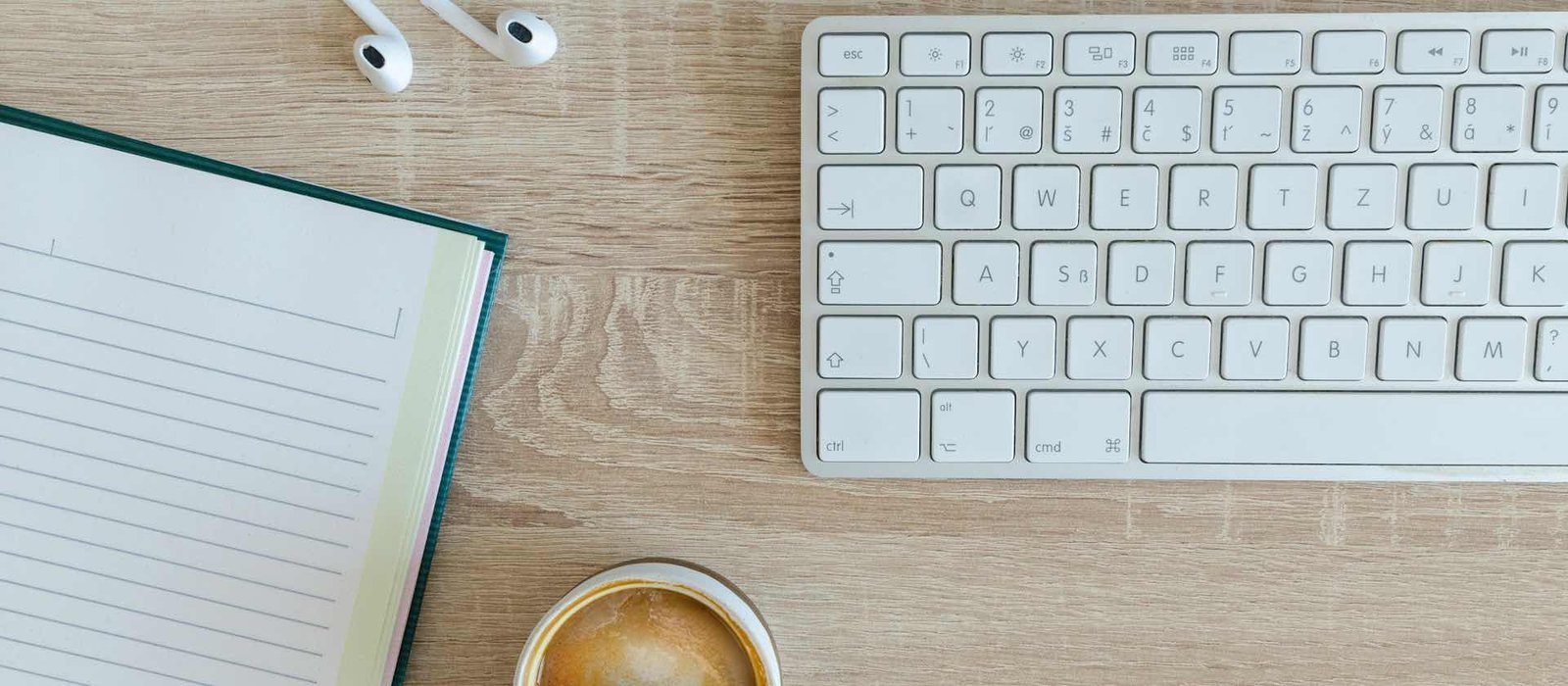 Blogging and freelancing newsletter workspace with keyboard and notebook
